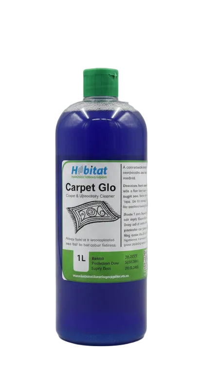 A 1L bottle of Habitat Carpet Glo stain and cleaning cleaner, filled with bright blue liquid and topped with a green cap, standing on a dark gray laptop lid against a plain light gray wall.